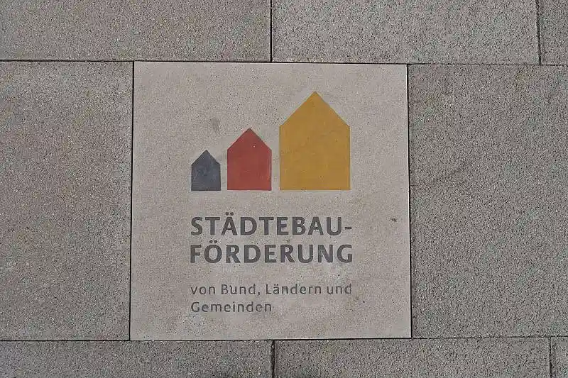 Gehwegplatte mit dem Bundeslogo der Städtebauförderung